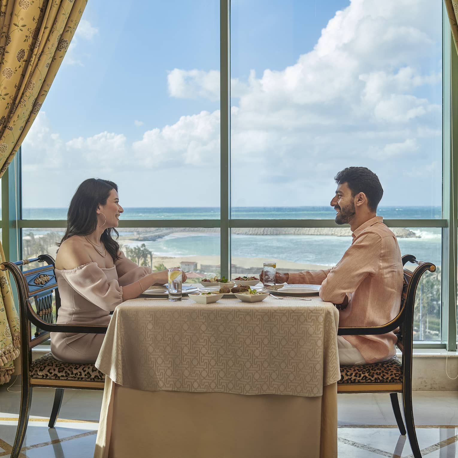 Couple enjoys a meal at Byblos Restaurant with views of the Mediterranean Sea