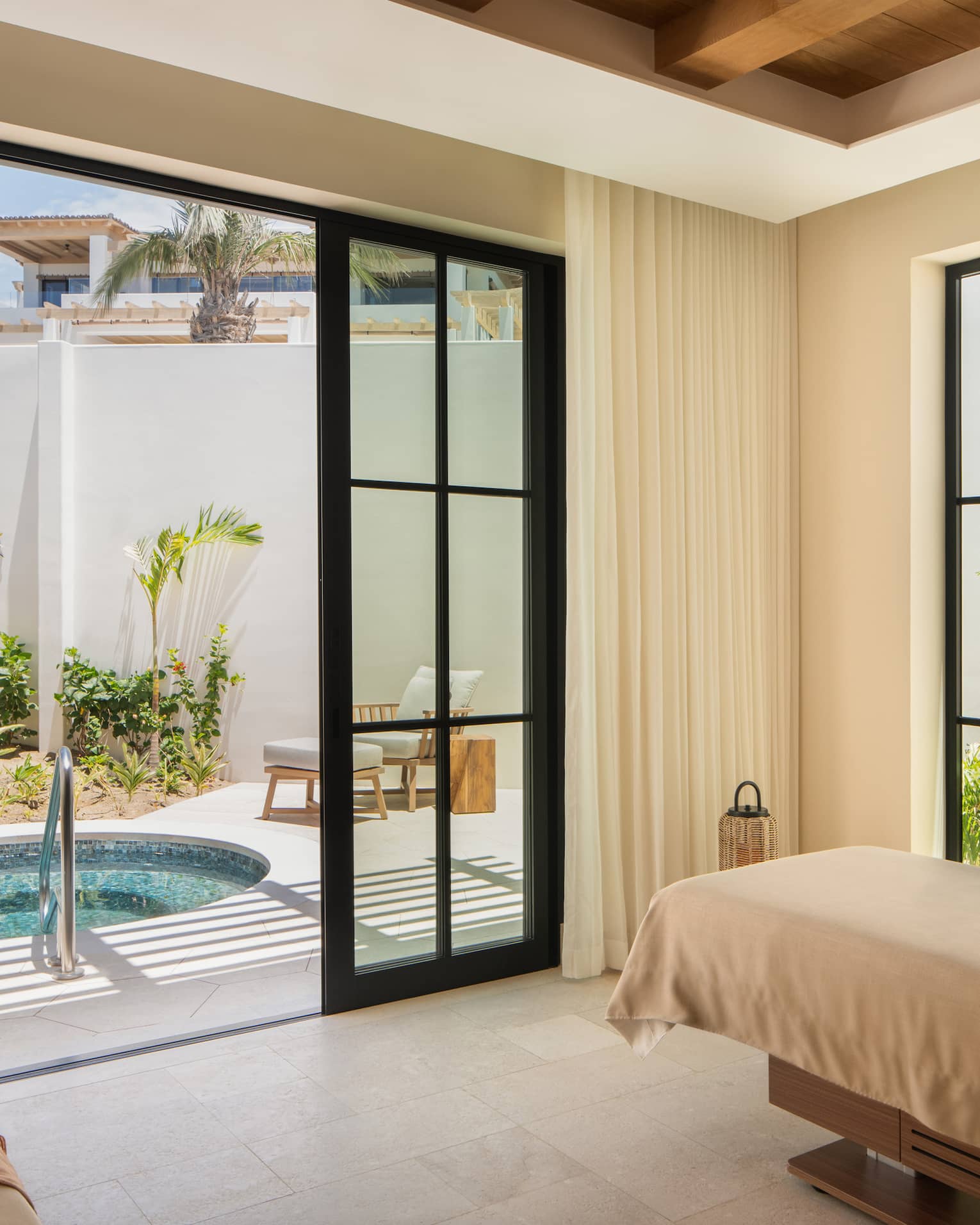 Luxury spa treatment room with access to private outdoor tub at Four Seasons Resort Cabo San Lucas at Cabo Del Sol