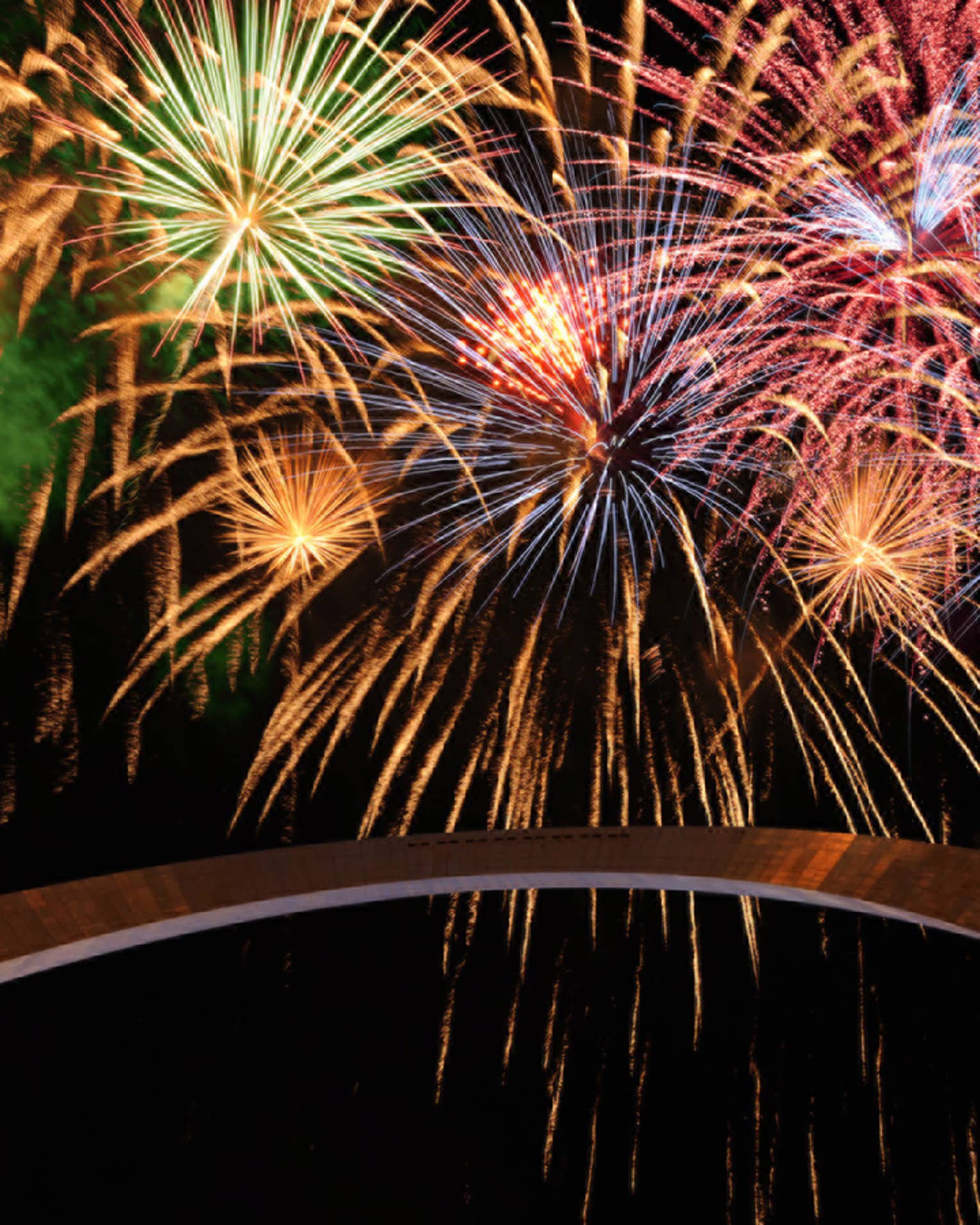 Colourful fireworks light up a night sky over Gateway Arch