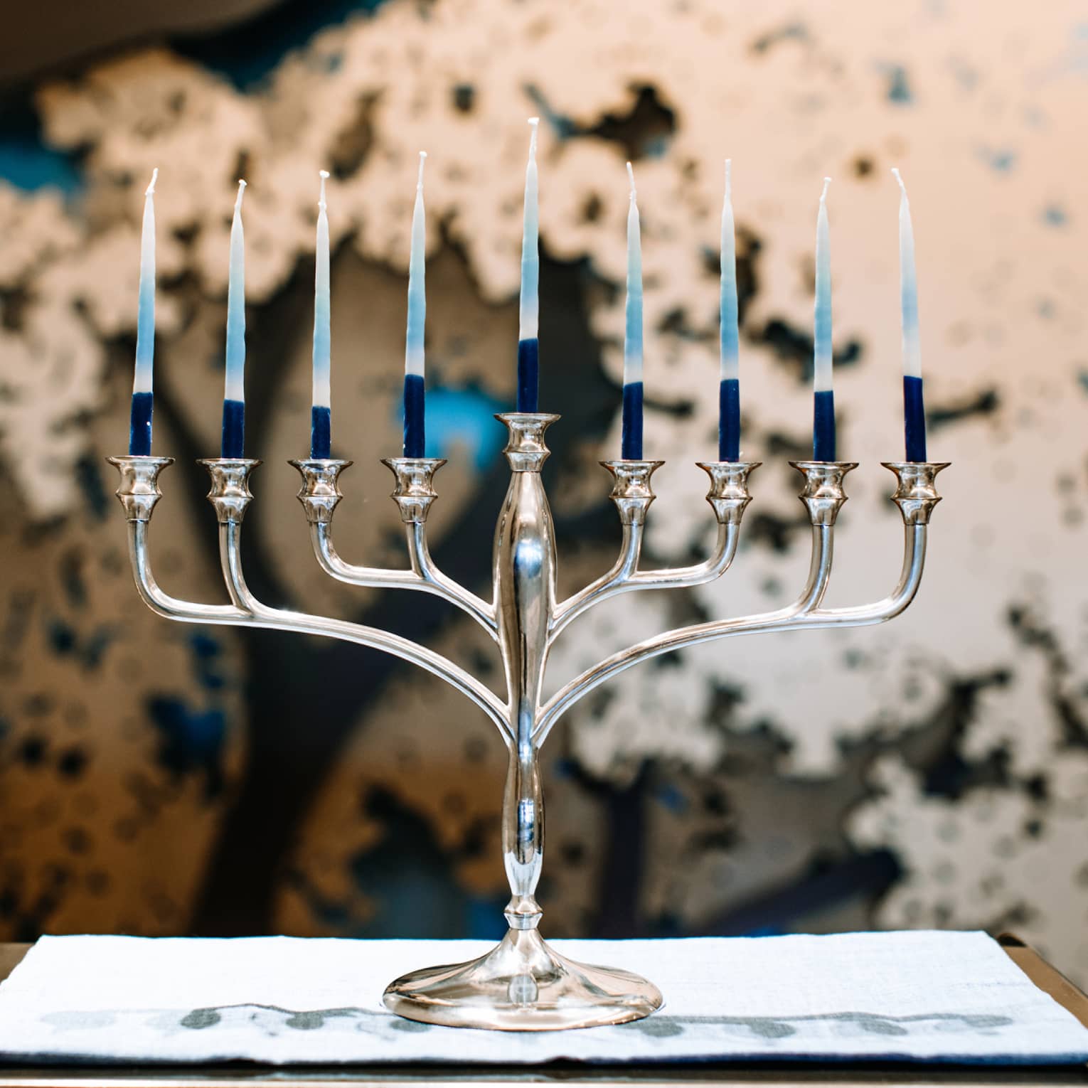 A silver menorah with 9 candles.