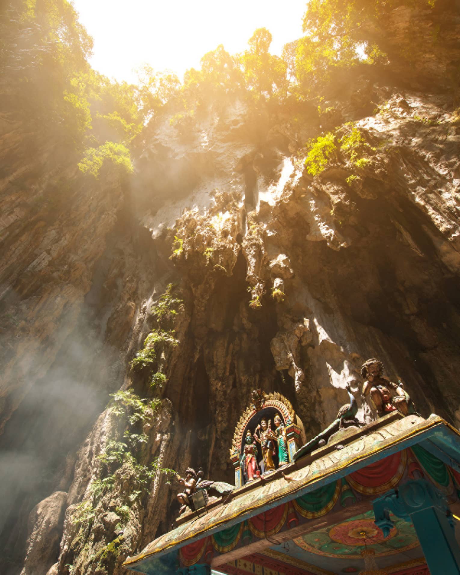 View looking up at rocks through Hindu temple at Batu caves in Malaysia