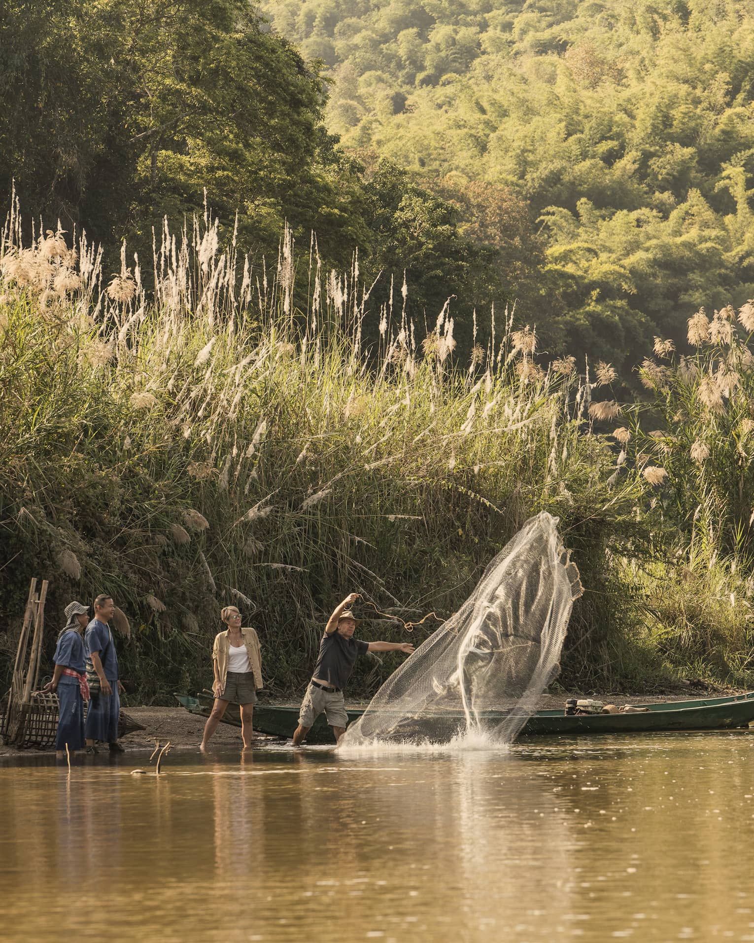 Local fisherman casting net in river during cultural activity