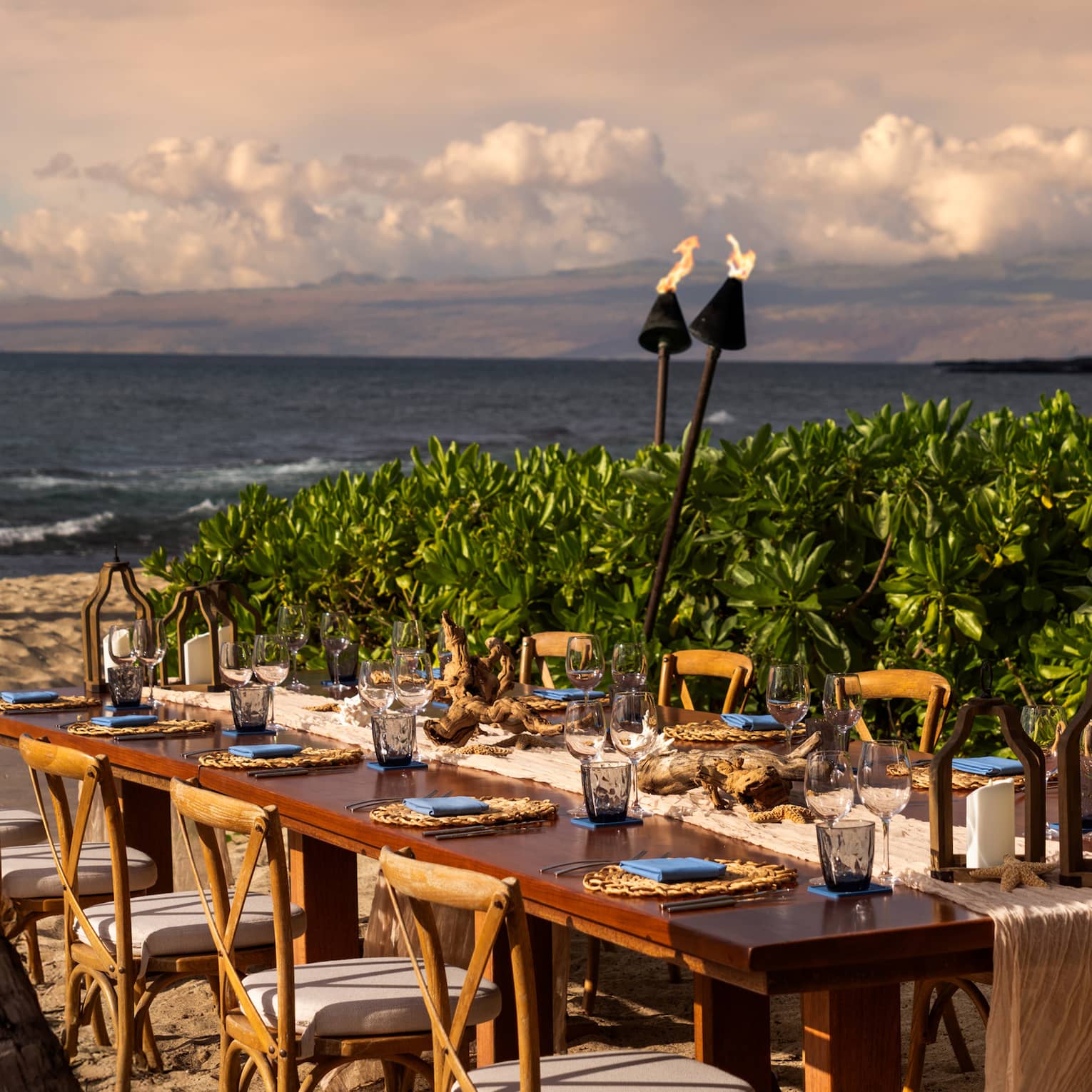 Private dining table seating 10 on the beach in tropical settig