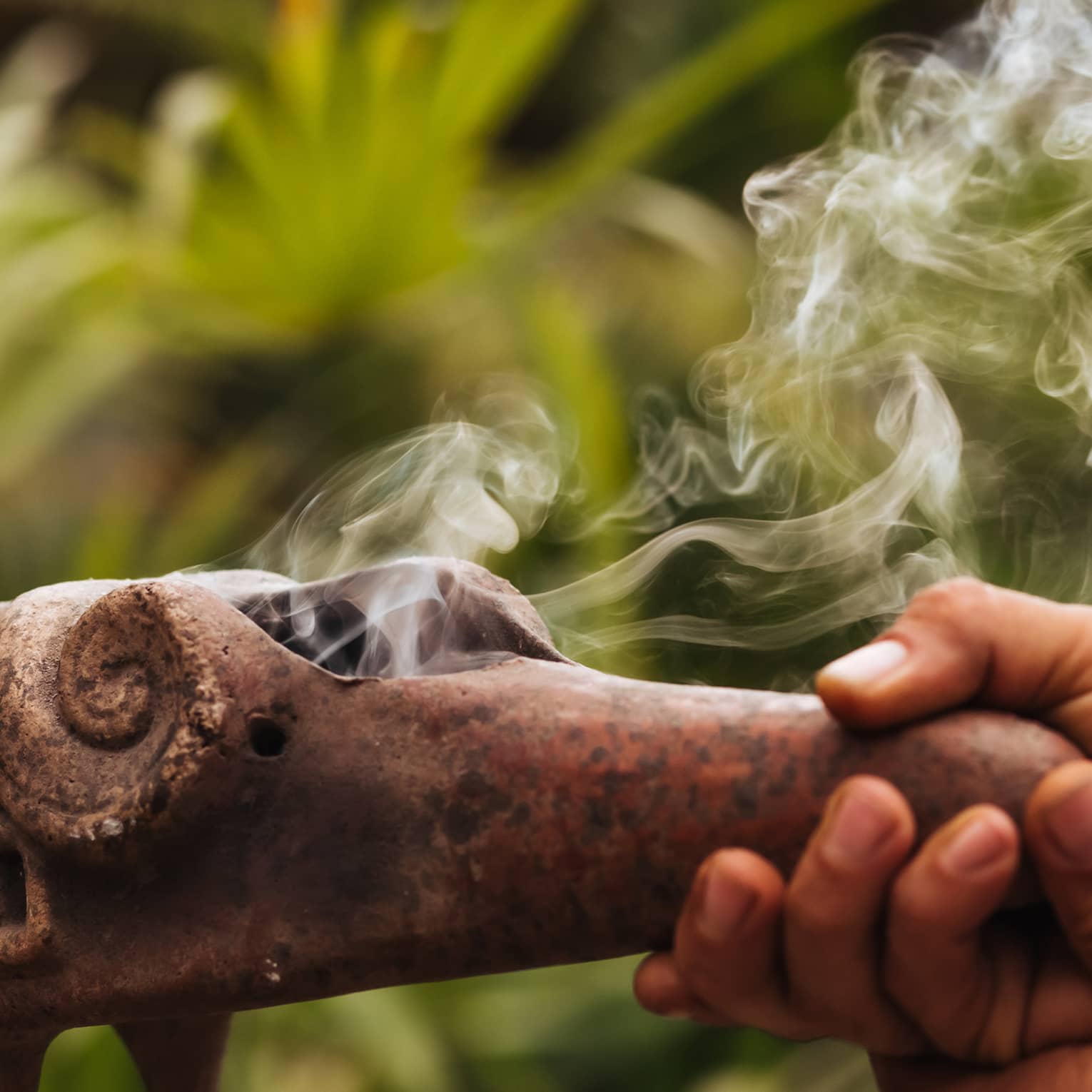 Smoke emerges from traditional Mayan copal pipe