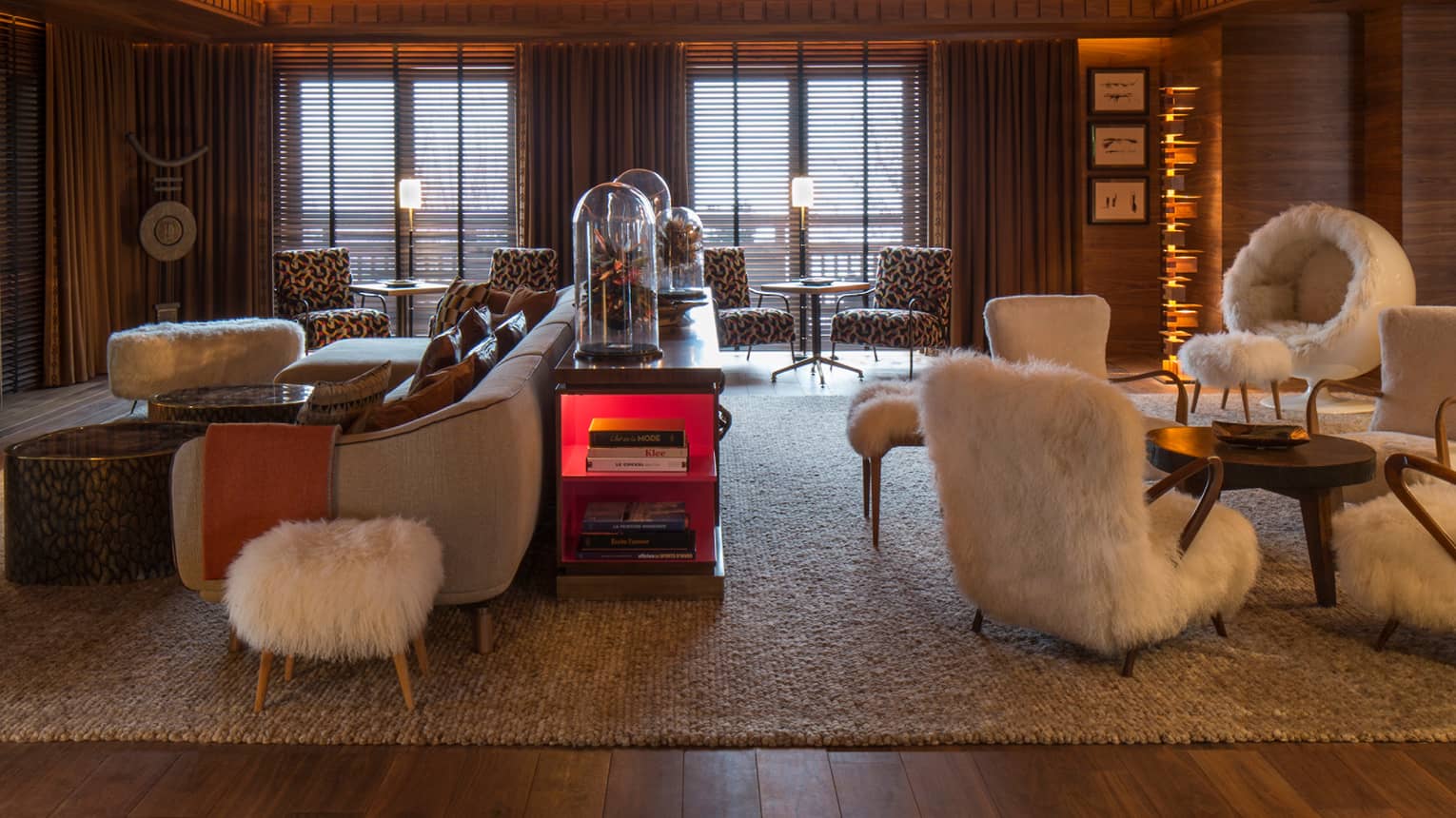 Lobby Lounge wood angular ceiling with lights over retro-style furniture, white faux fur chairs