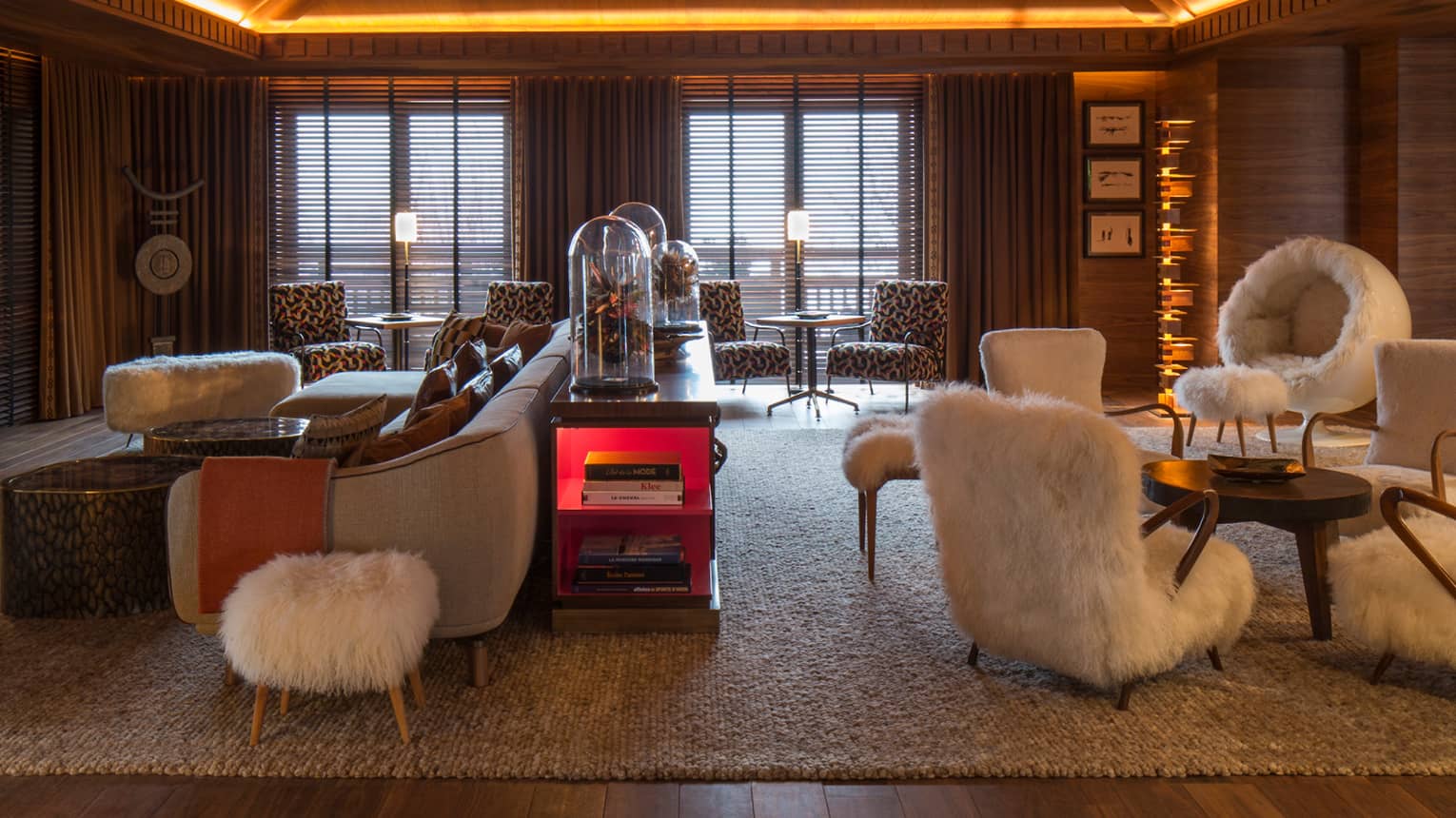 Lobby Lounge wood angular ceiling with lights over retro-style furniture, white faux fur chairs
