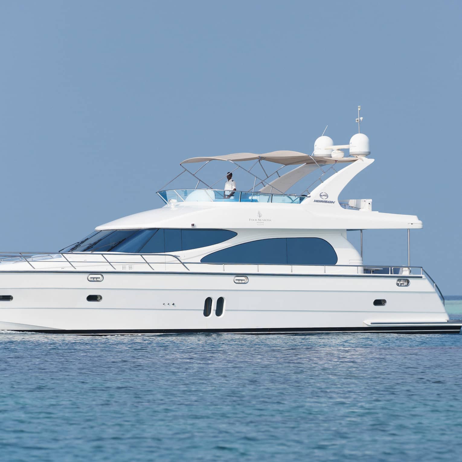 Small white private luxury yacht sailing on ocean