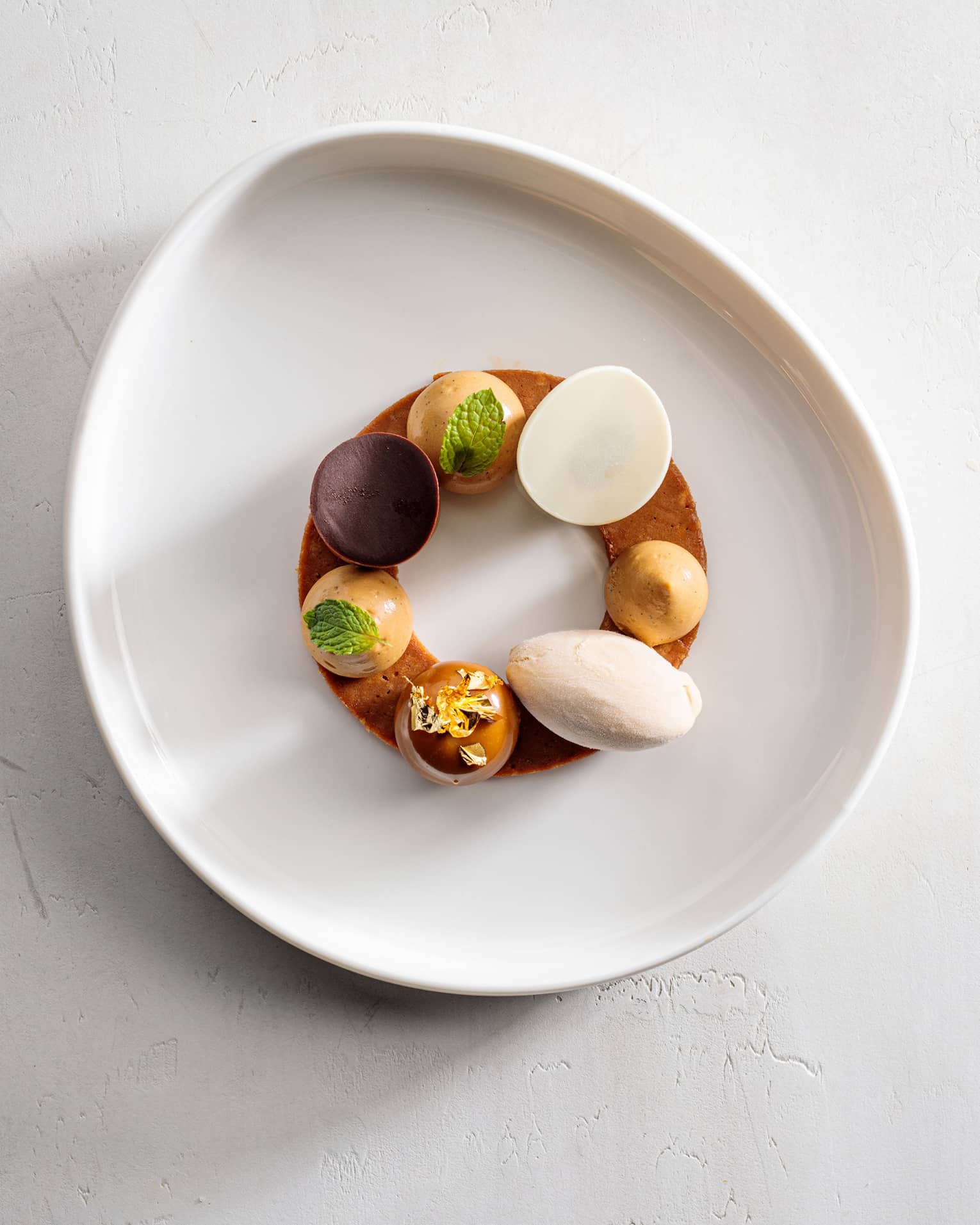 A white plate with an assortment of small food on it.