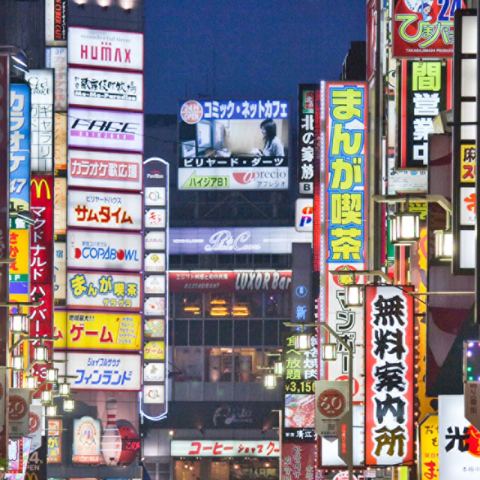 Crowds under Tokyo lights, colourful billboards