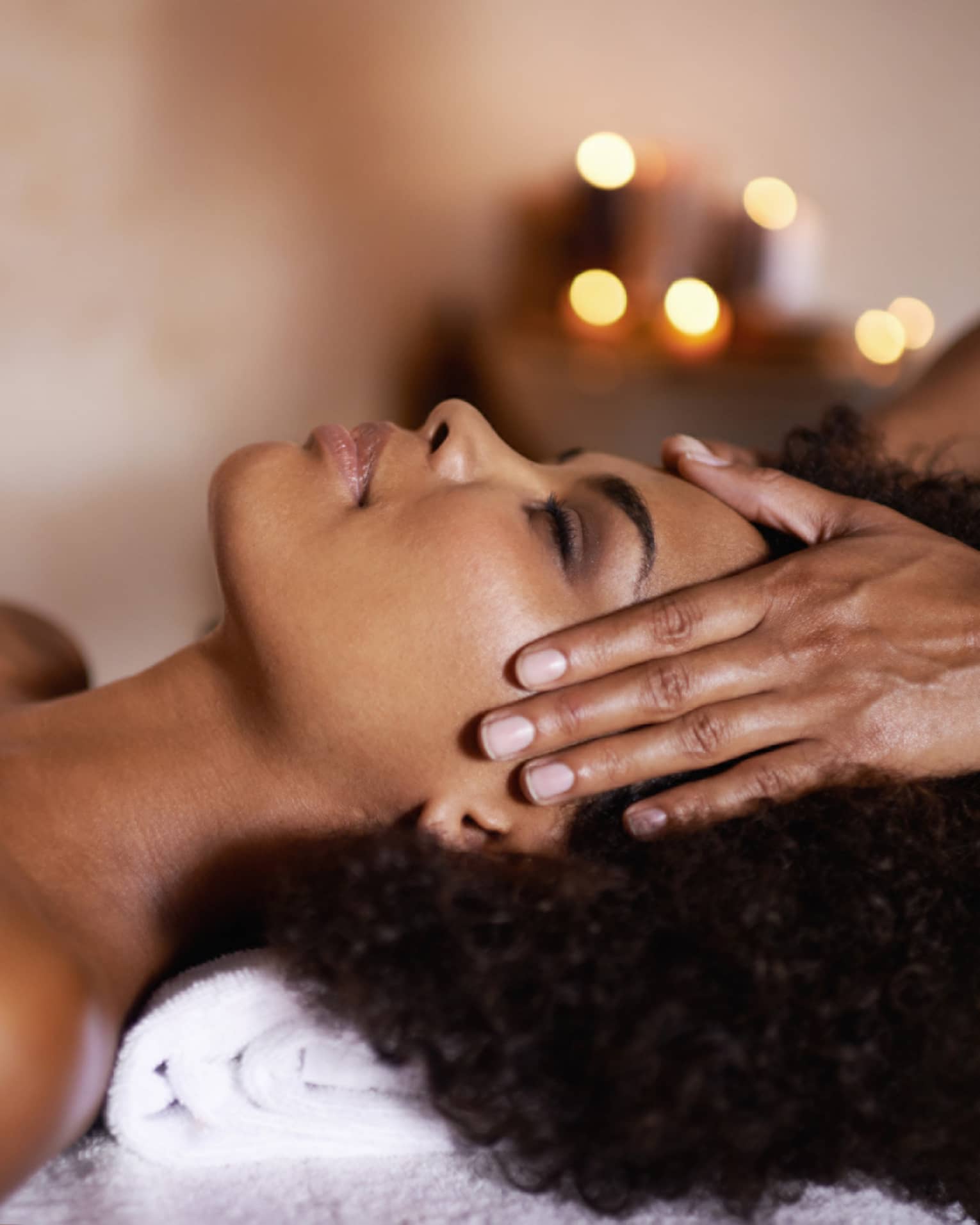 Woman laying down on massage bed getting a massage.