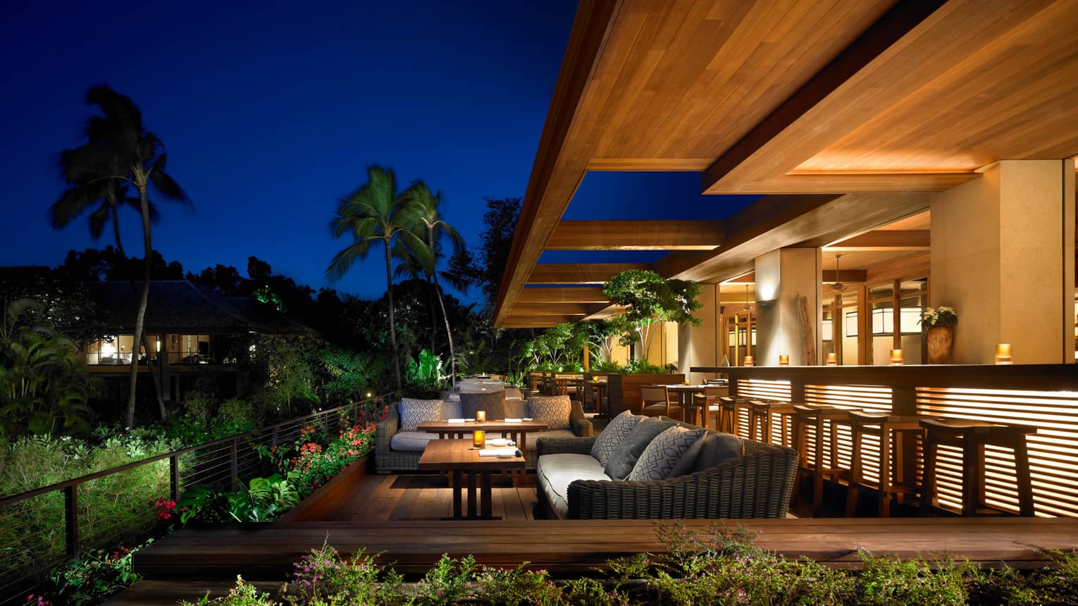NOBU Lanai  restaurant patio lounge tables, bar with lights at night