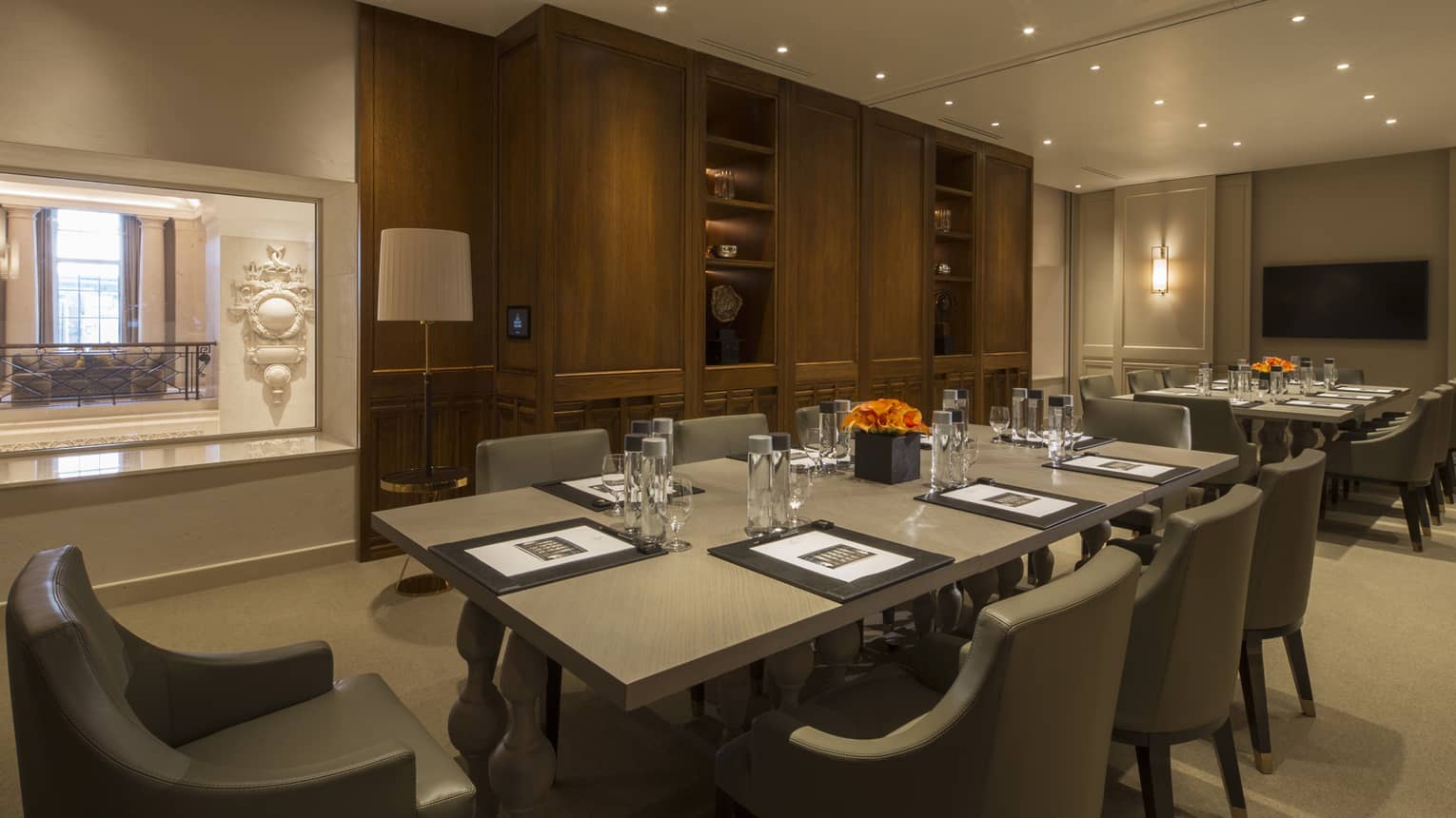Serica Meeting Room two long boardroom tables with modern chairs, window to hall