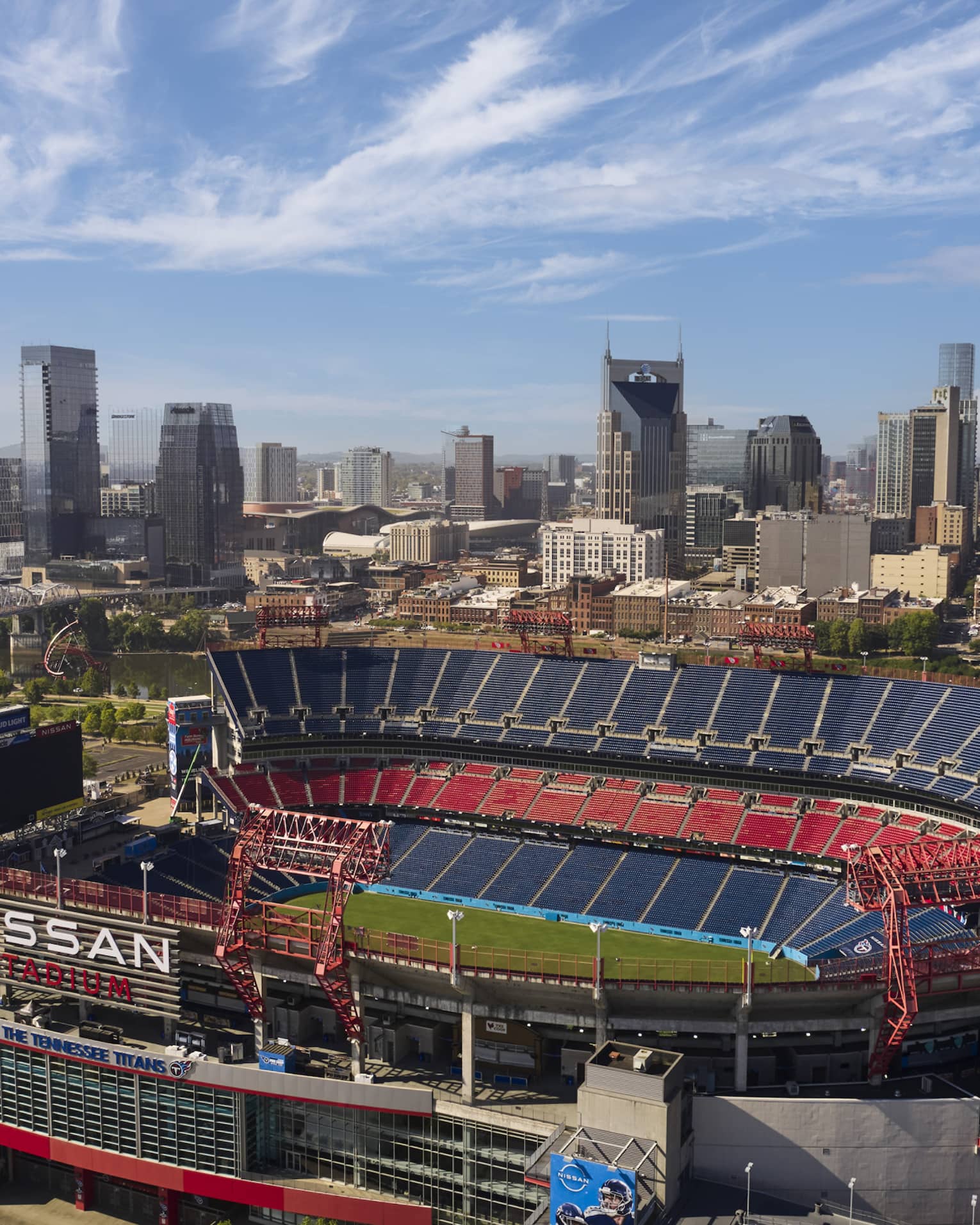 A sports stadium with a city in the background.