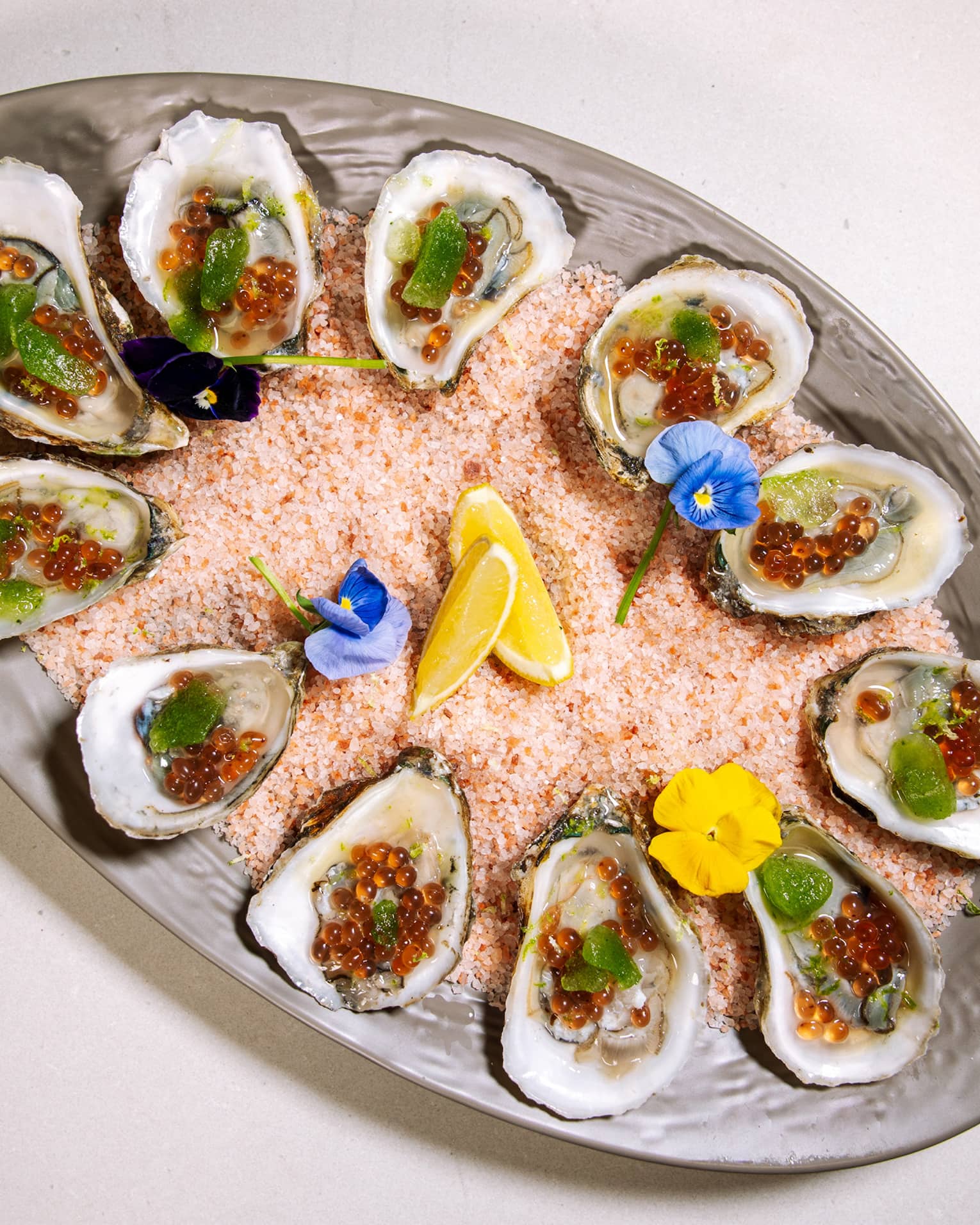 Oysters on a large grey plate.