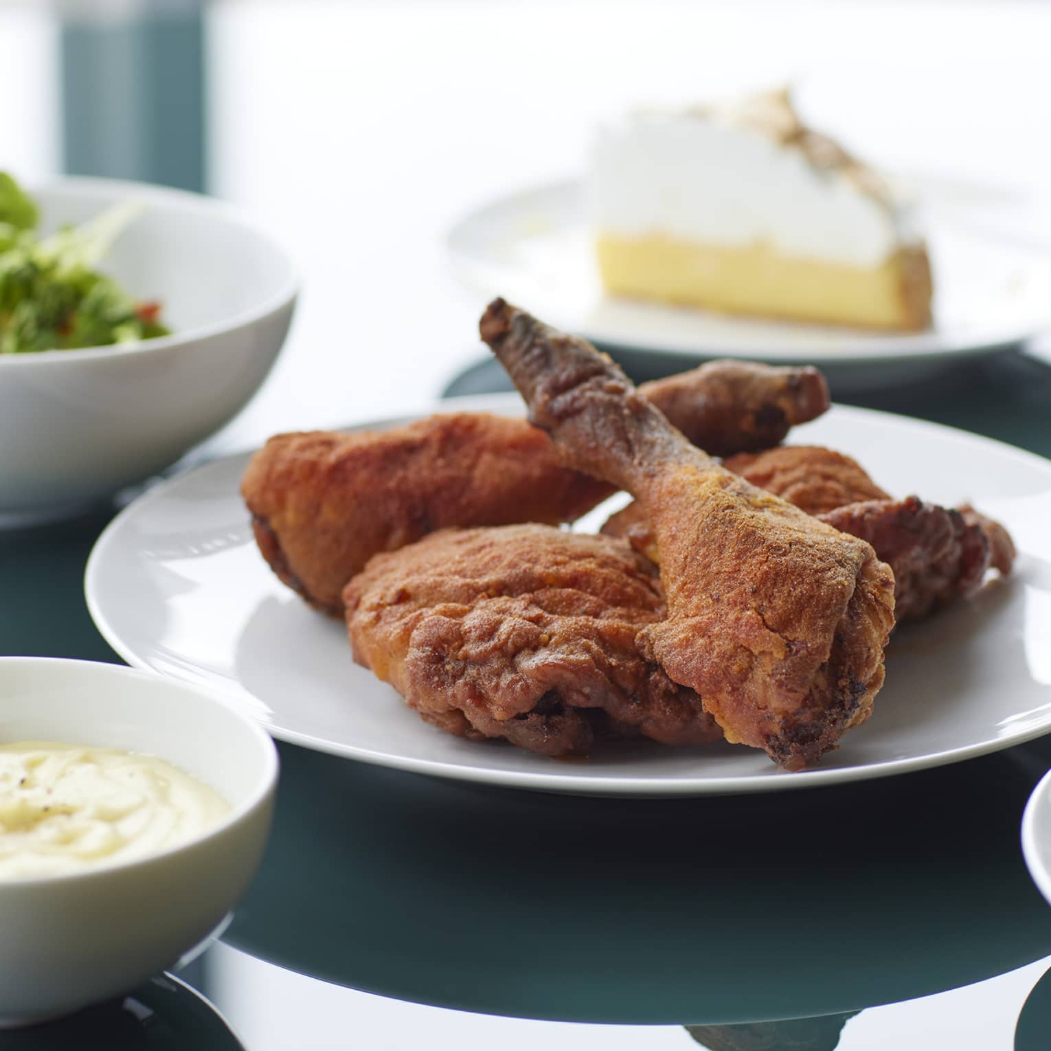 Marunouchi Fried Chicken with Cobb Salad & Kale Dressing, Braised Kale, Mashed Potatoes, Cornbread, House-made Pickles, Ranch Dressing and Lemon Meringue Pie