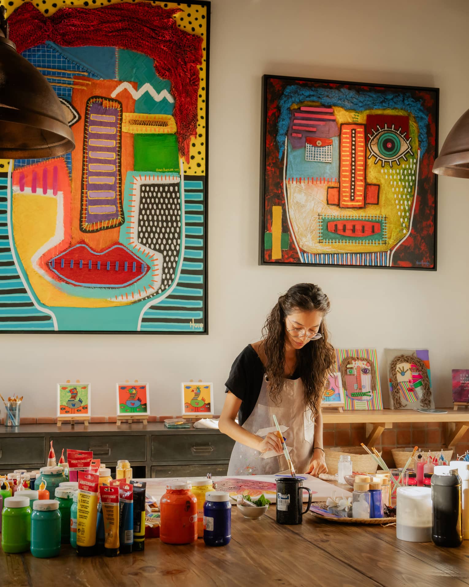 Woman paints in colourful art studio at luxury resort