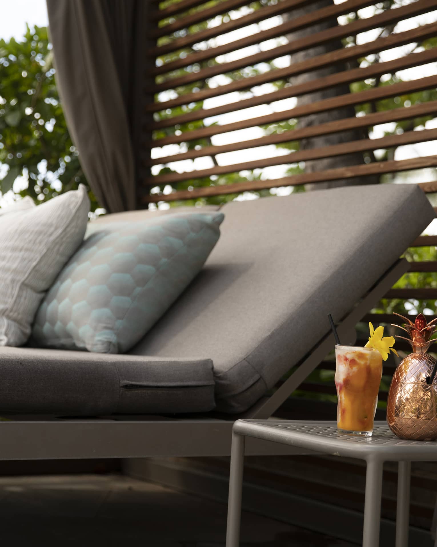 Cabana sunbed and cocktail in a tropical resort location