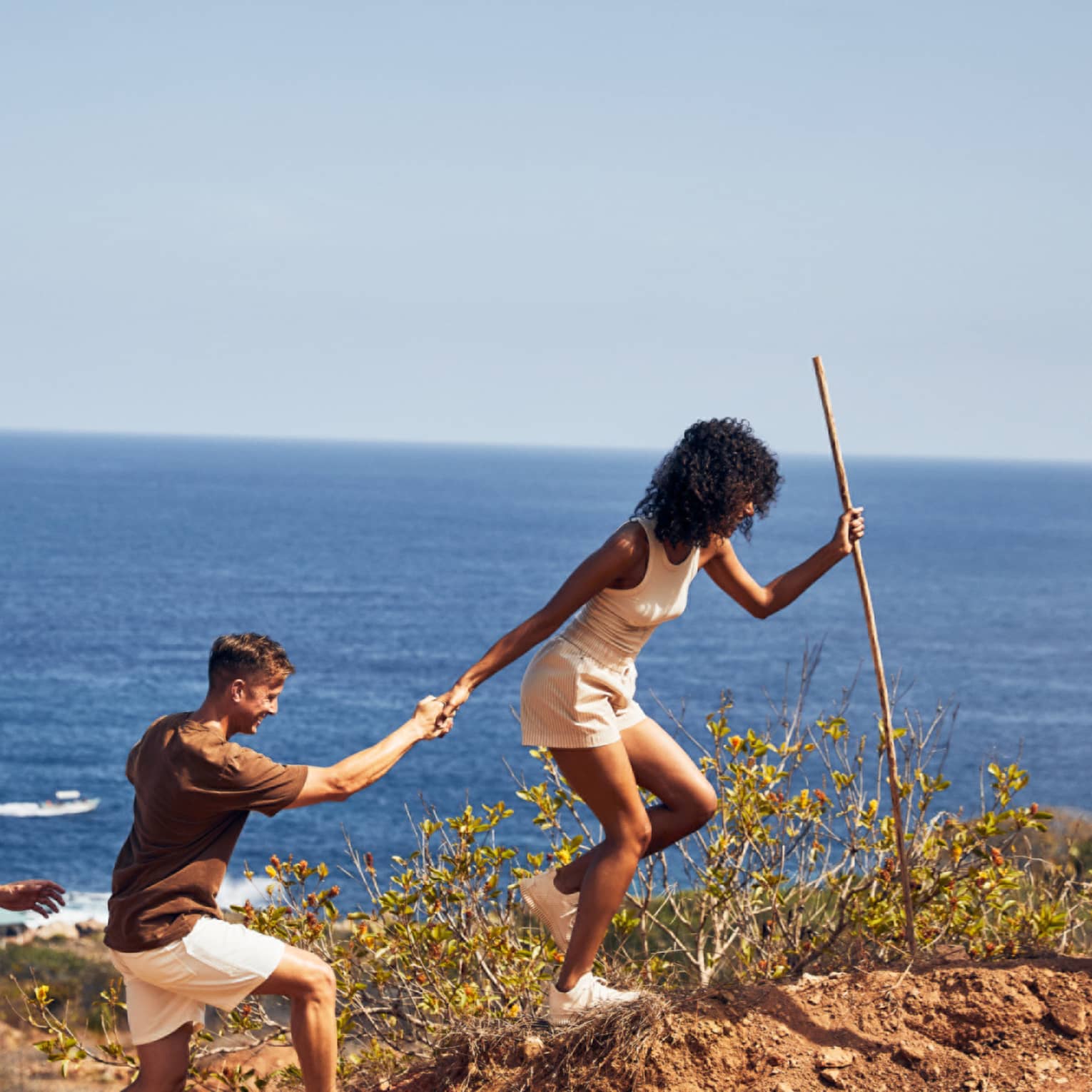 A group of people hiking along a beach.