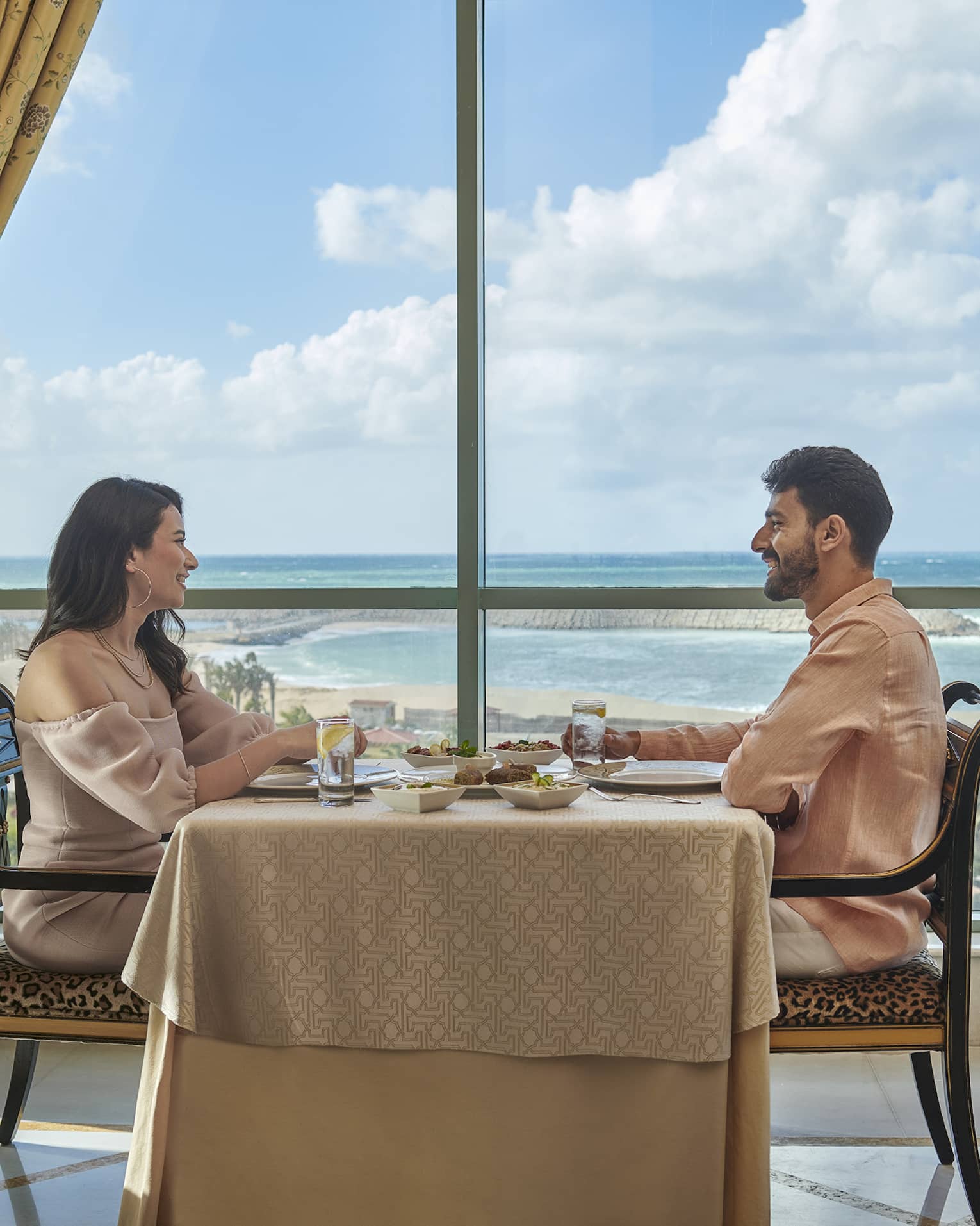 Couple enjoys a meal at Byblos Restaurant with views of the Mediterranean Sea