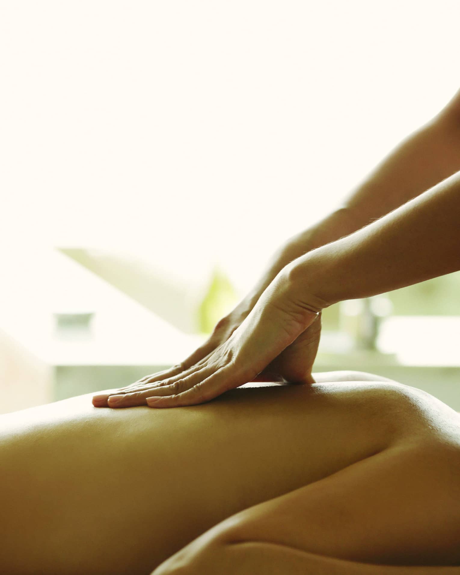 Close-up of a person receiving a relaxing back massage in a spa setting.
