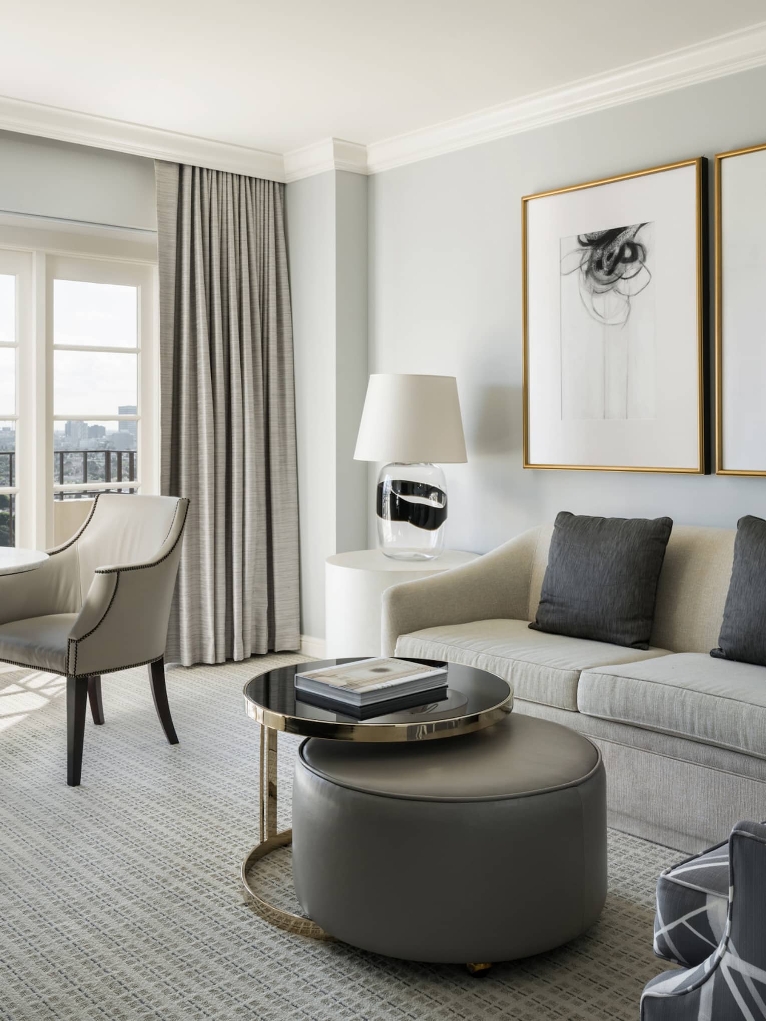 Hollywood Suite grey sofa, armchair, coffee table by cafe table, large window