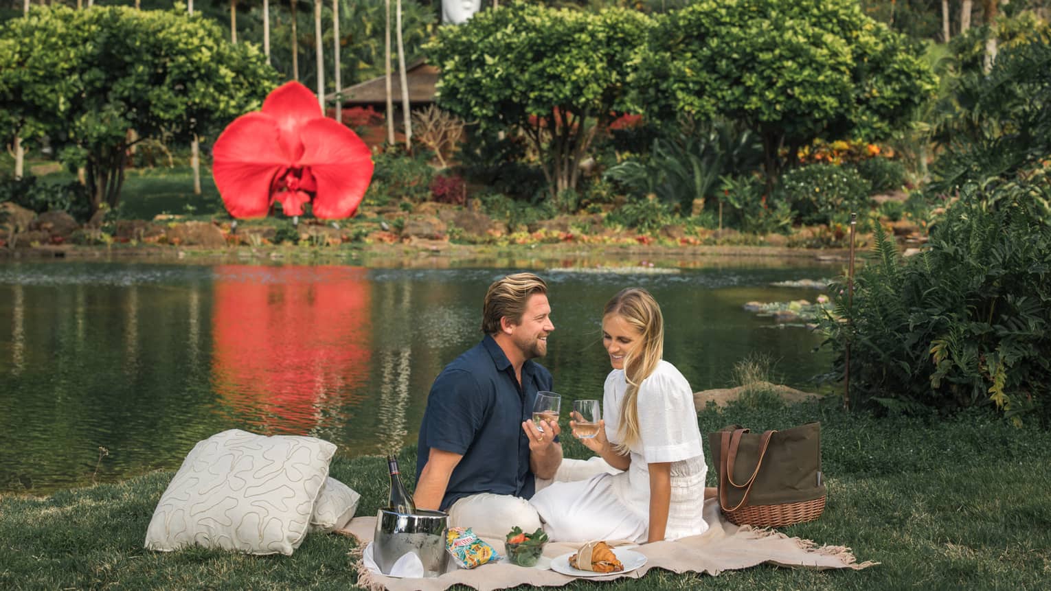 Man and woman have a picnic near lake on Lanai, Hawaii