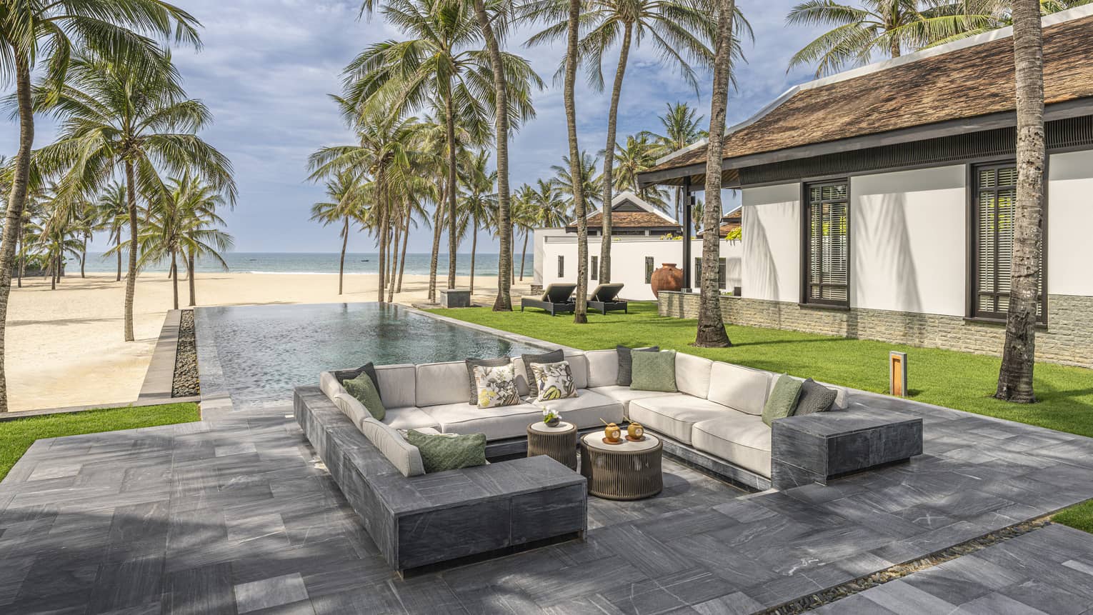 Outdoor pool terrace of a private luxury villa on the beach in tropical location