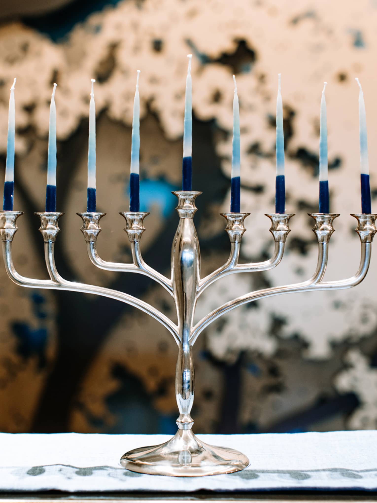 A silver menorah with 9 candles.