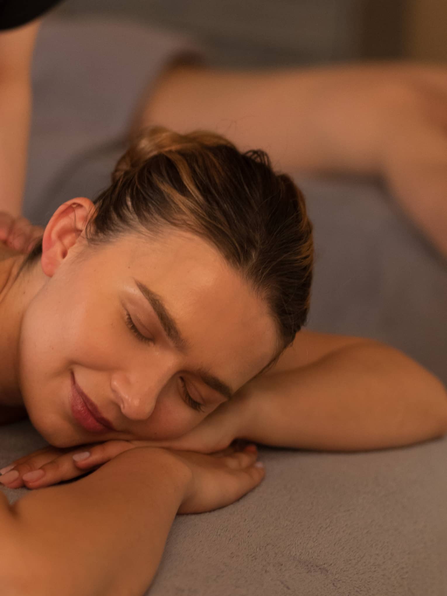 Two people laying on massage tables getting a massage.