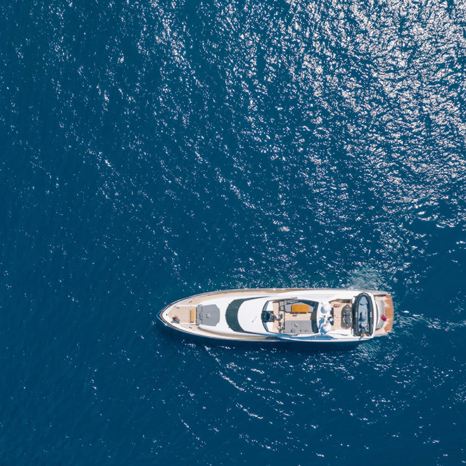Aerial view of yacht cruising in blue water