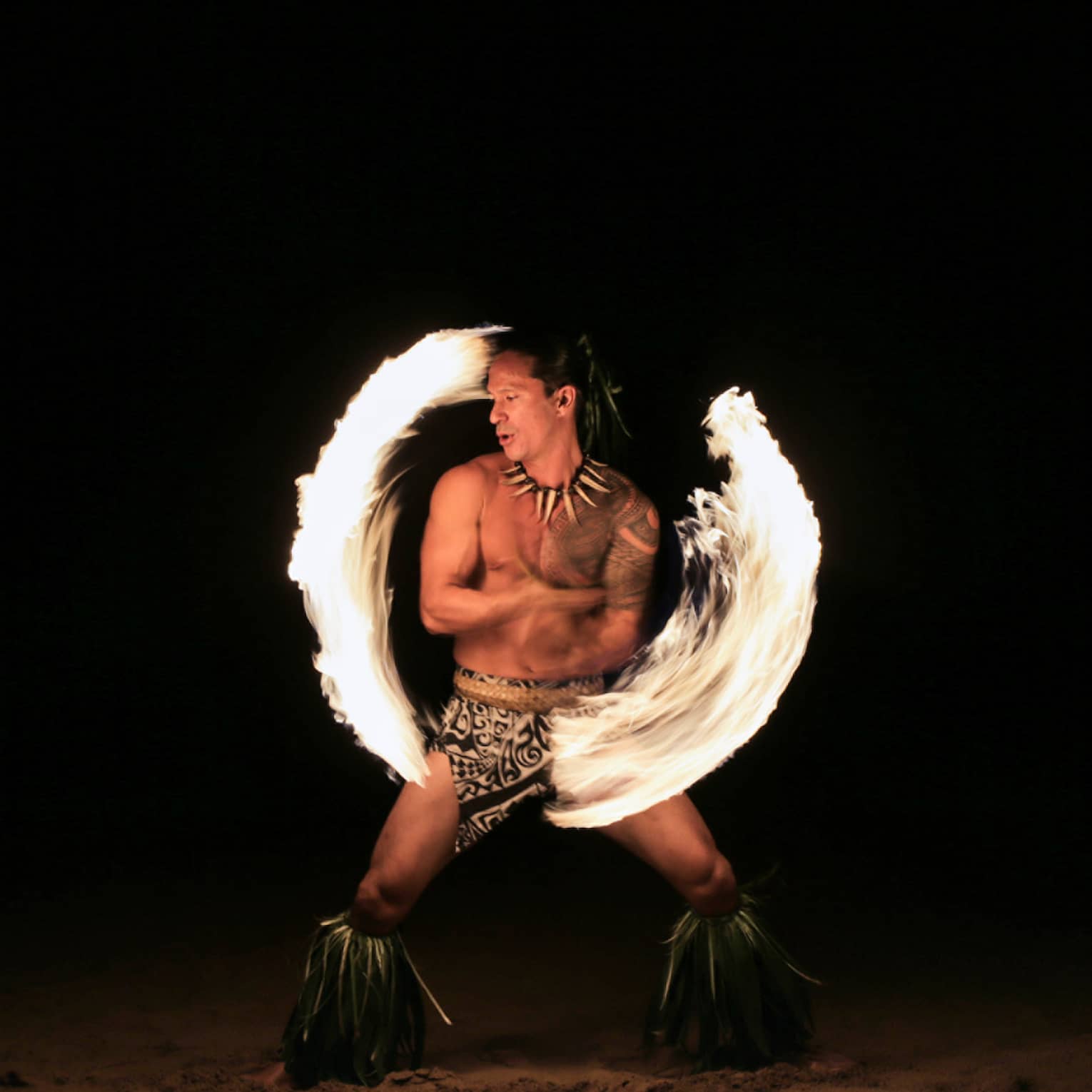 Fire dancer spins fire on the beach