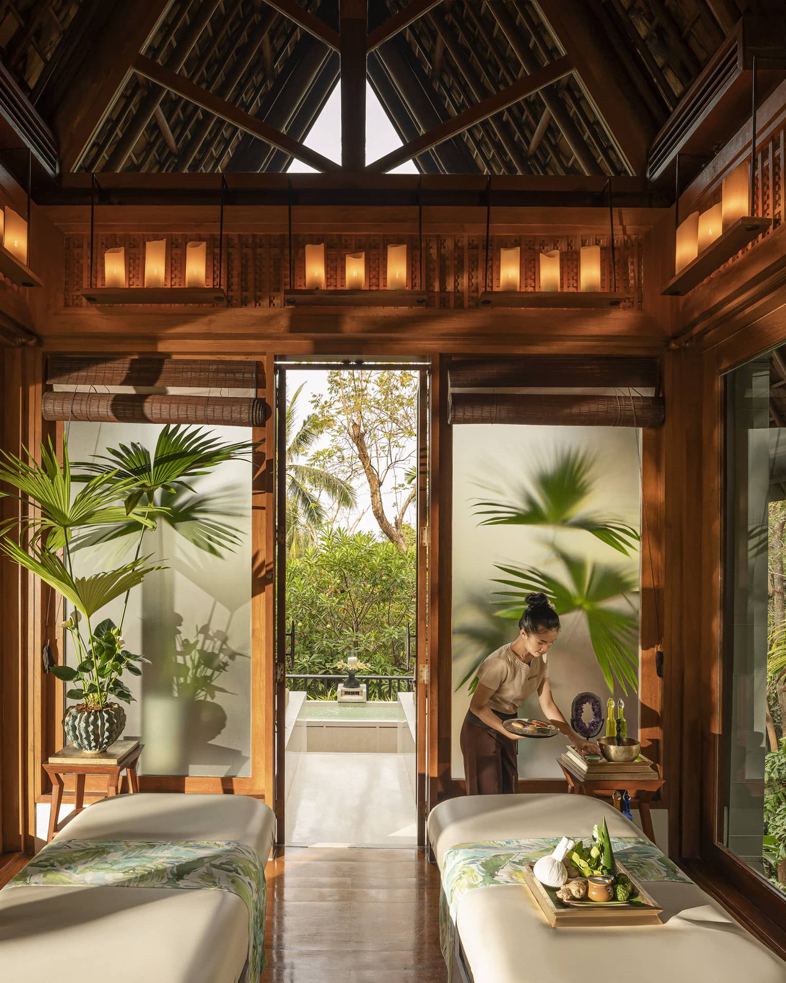 Spa team member prepares couples treatment room