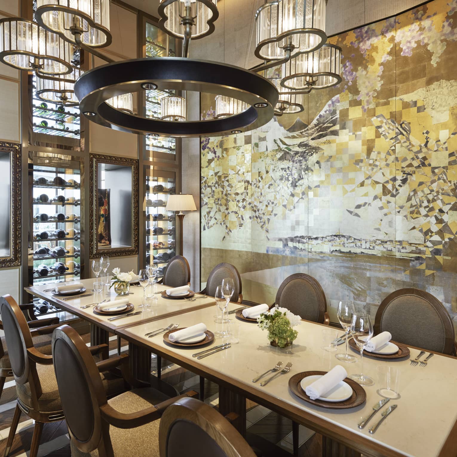 Est dining room with table set for eight, muted cream decor, circular chandelier, hardwood floors