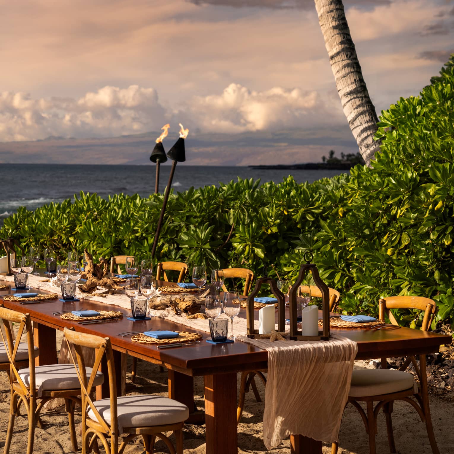 Private dining table seating 10 on the beach in tropical settig