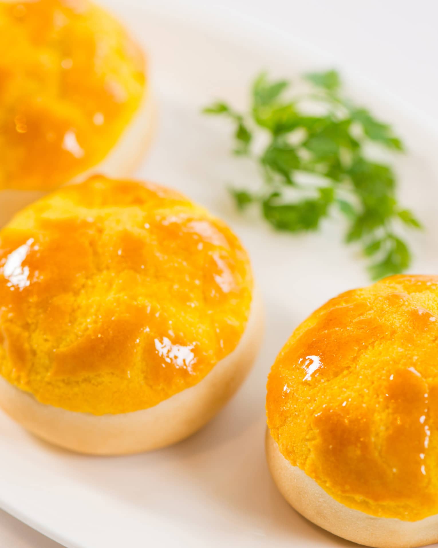 Three Baked Barbecued Pork Buns with Pine Nuts on White Plate