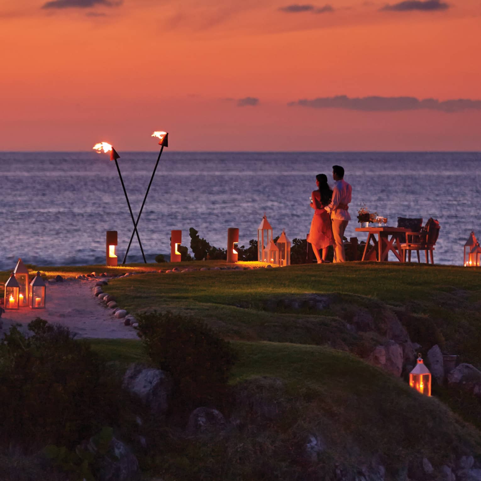 ,A group gathered for dinner outside during sunet.