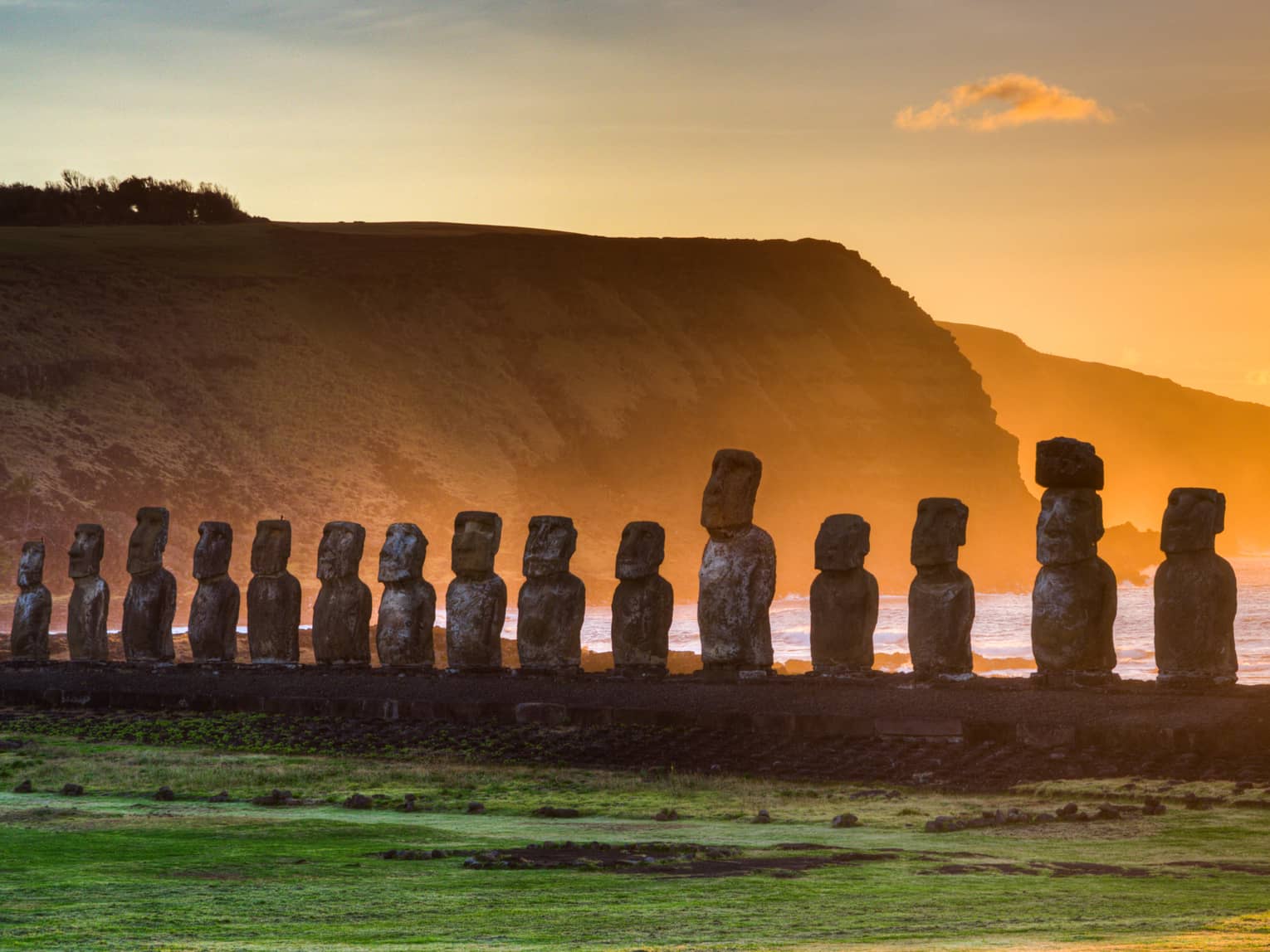 Stone statues of Easter Island in the sunset