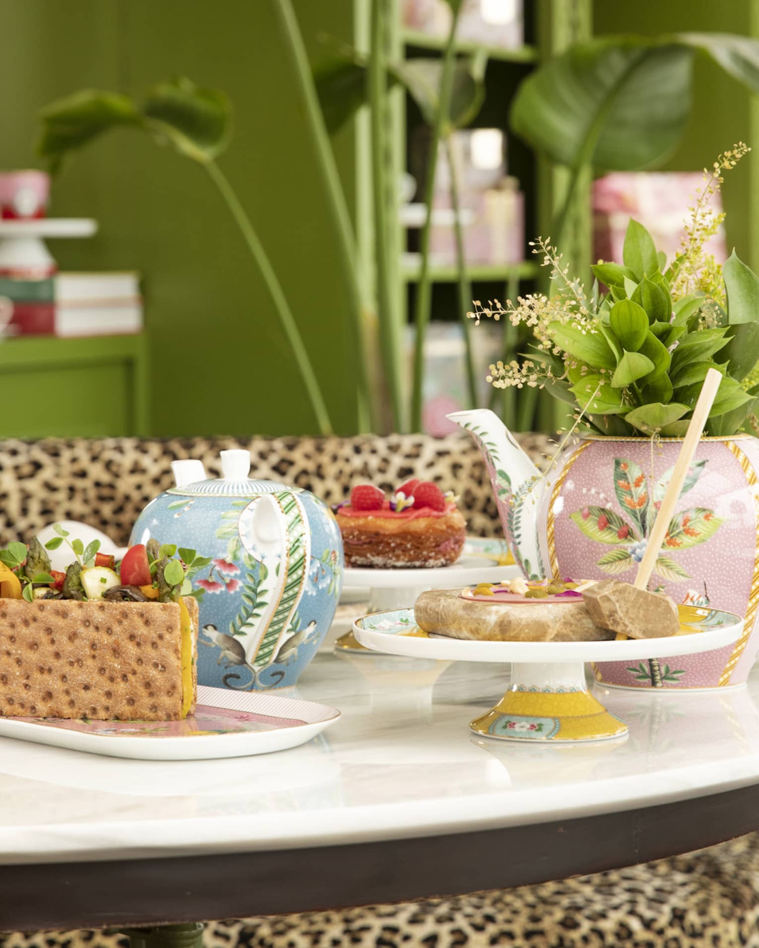 Round table with colourful tea cups and sweets at YASEMIN