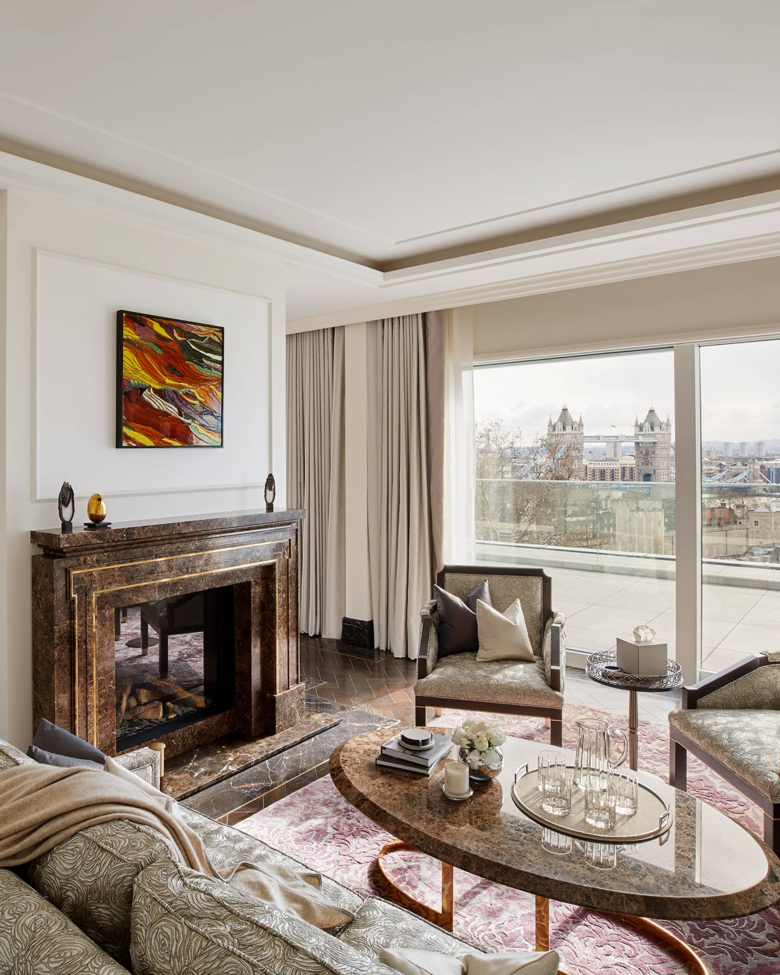 Elegant residence living room with fireplace and tall windows with river views