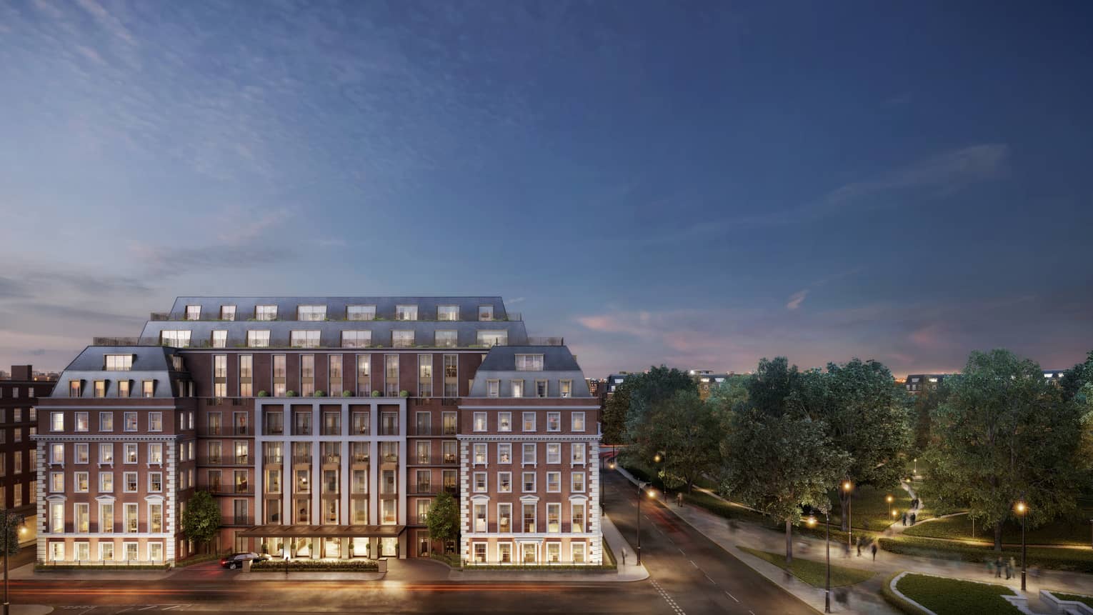 Wide view of Twenty Grosvenor Square historic building with lights against sky at dusk