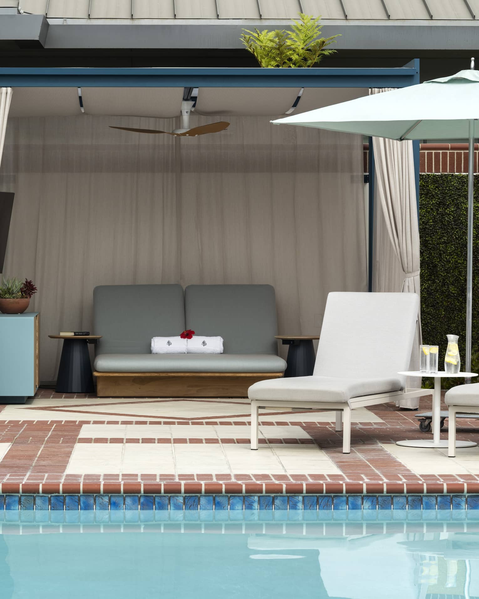 Pool with lounge chairs and umbrella, along with a canopy.