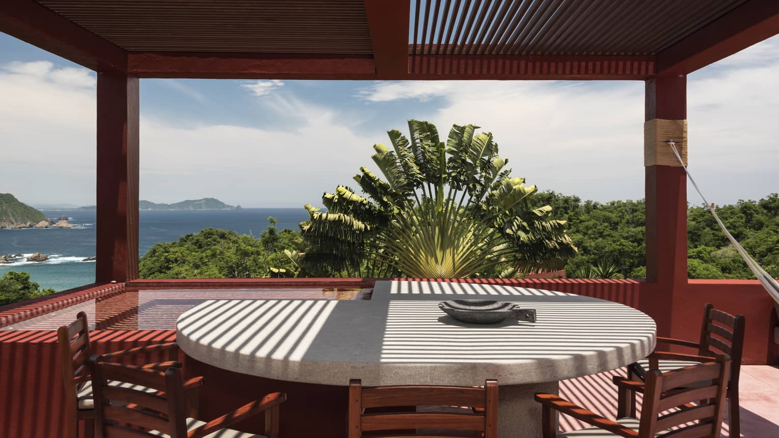 Covered rooftop terrace with dining table overlooking Tamarindo, Mexico ocean