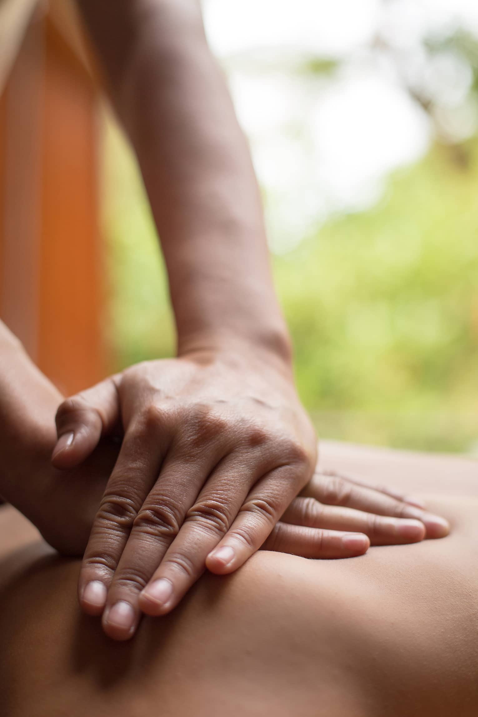Close up of hands massaging a back