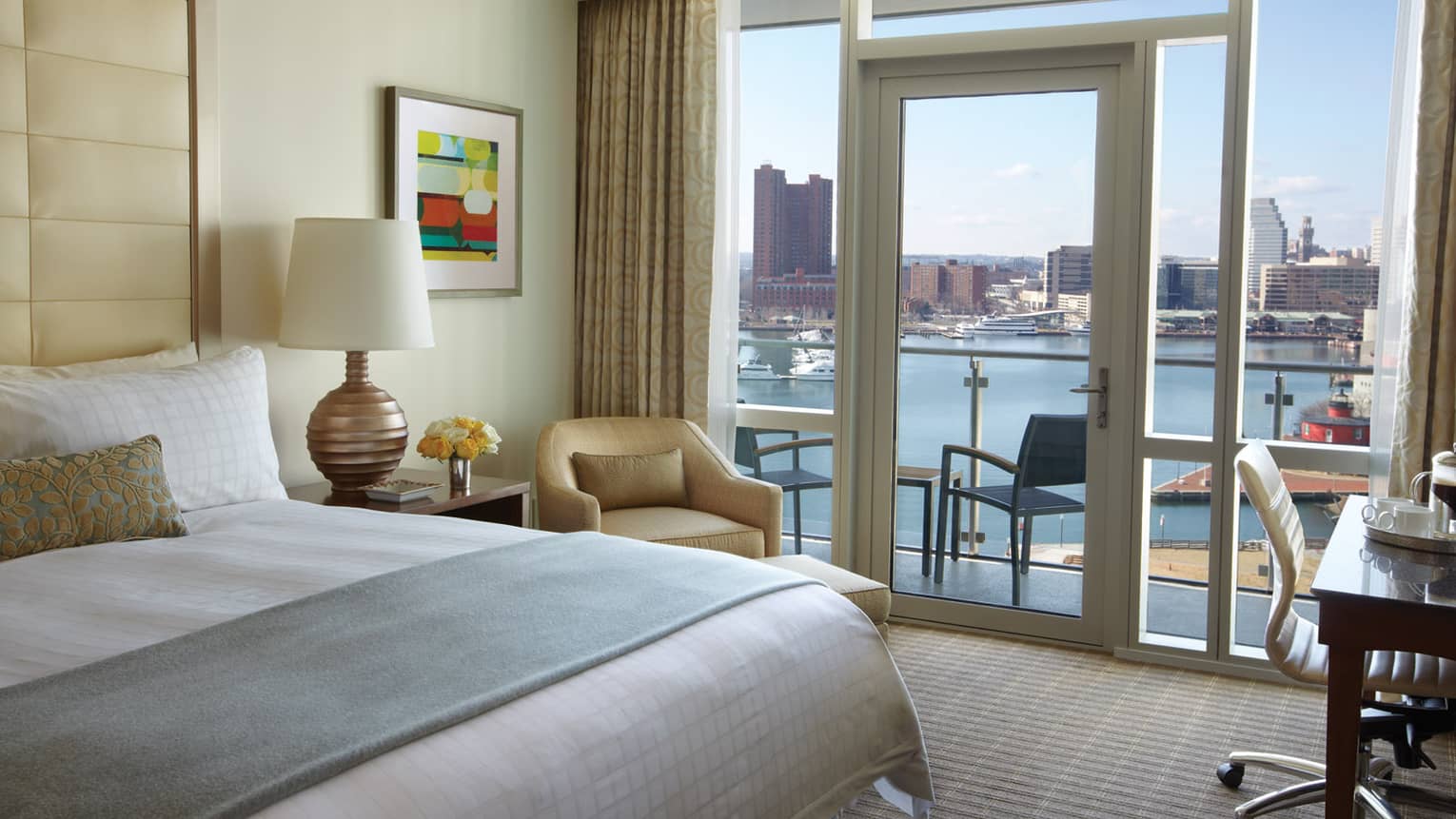 A luxurious king-size bed with plush bedding, a comfortable armchair and a large window offering stunning river views .