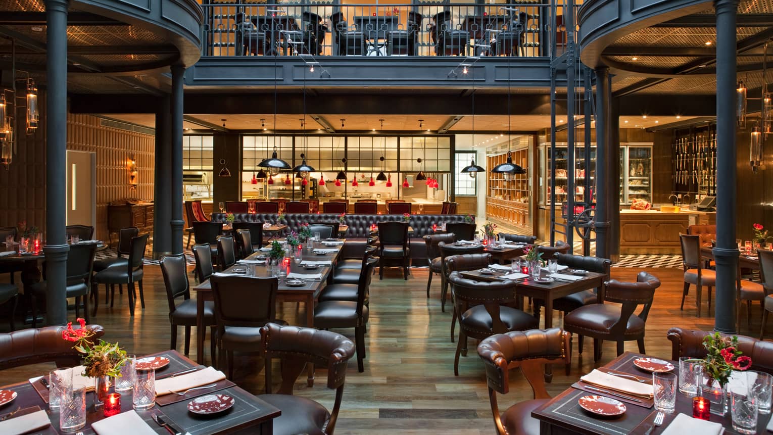 Elena large dining room with second-level balcony, black pillars, red candles and lights