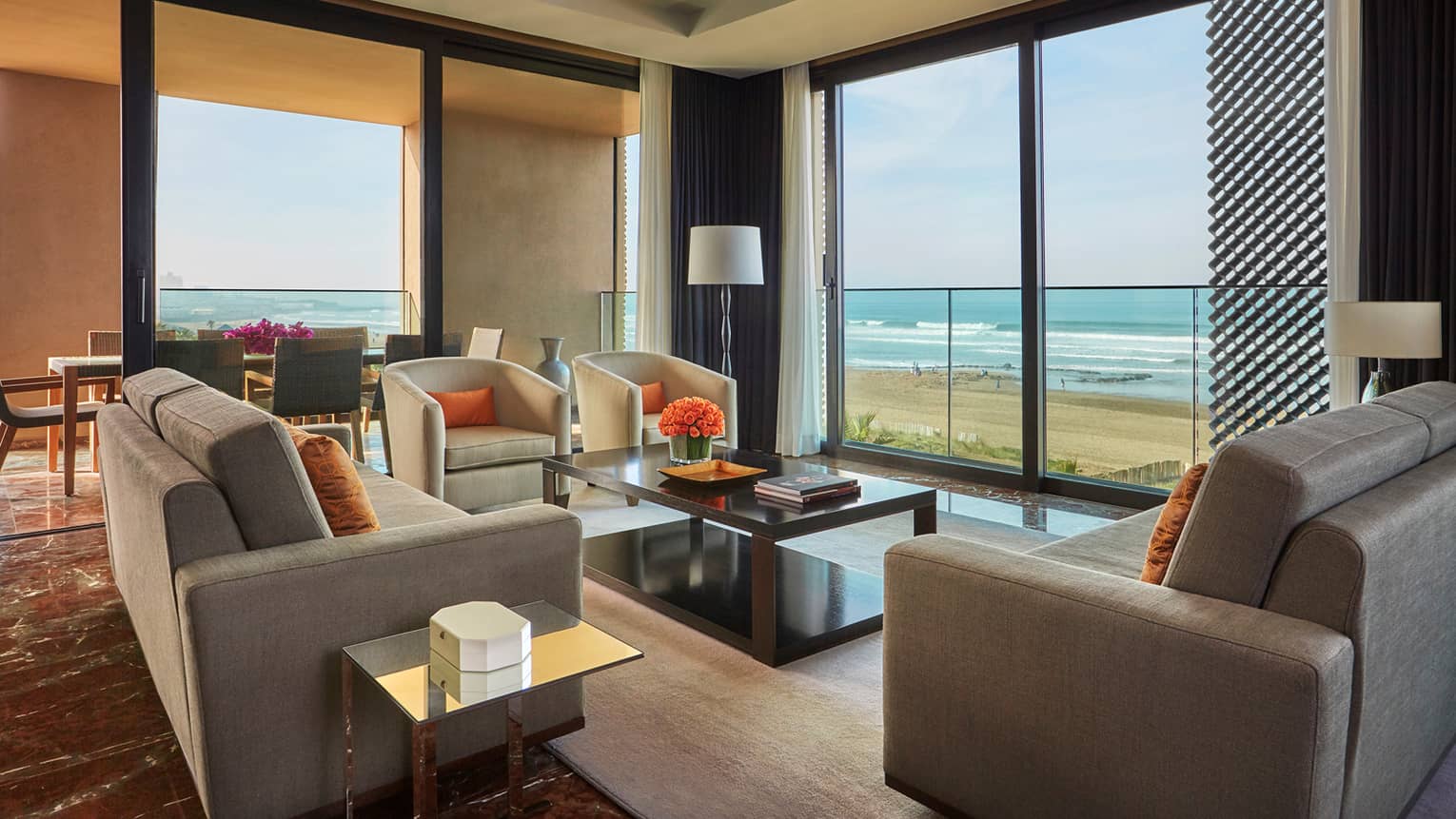 Imperial Suite Ocean View living room sofas, armchairs, corner windows with view of beach, Atlantic