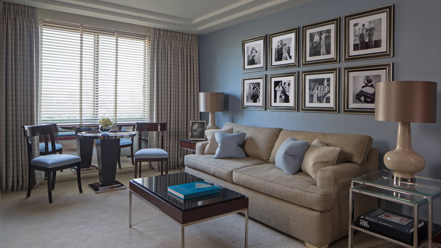 Westminster Suite sofa, table under rows of black-and-white prints, table, chairs by window