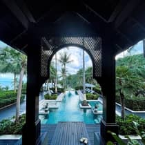 View of hotel pool from underneath breezeway