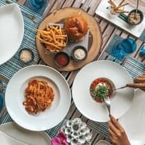 A guest enjoys a table full of various cuisine