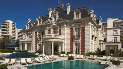 Exterior view of Four Seasons Buenos Aires hotel in historic white mansion with swimming pool